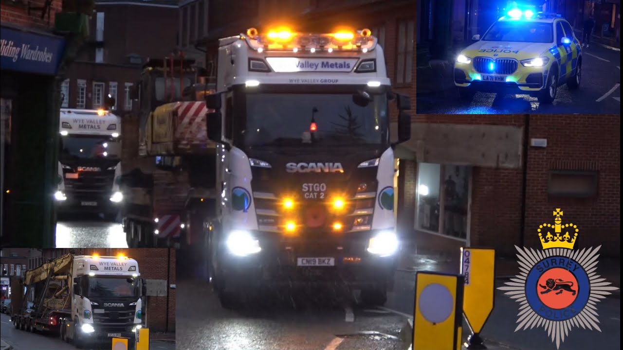 Police escort demolition equipment down one-way system in Leatherhead due to bridge restrictions.
