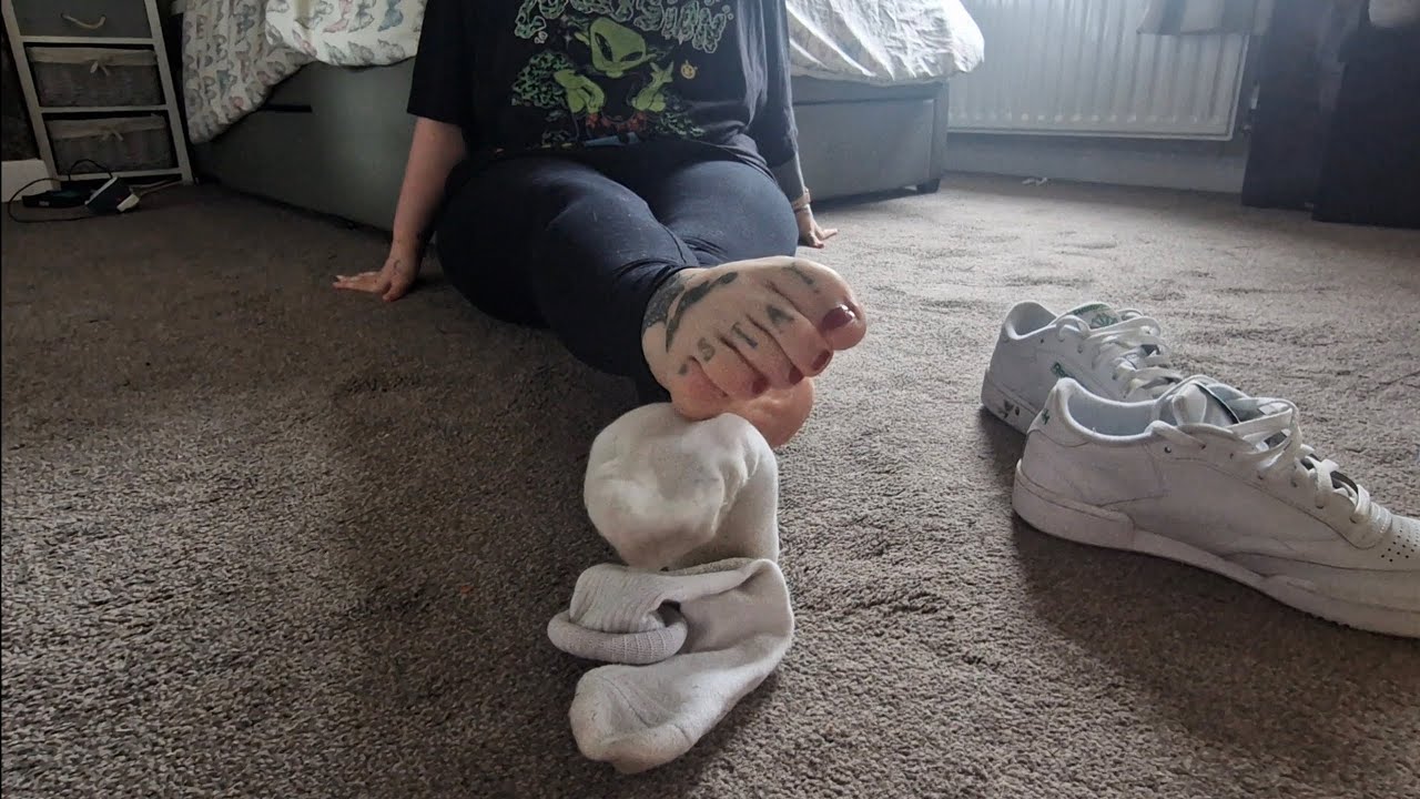 Girl shows off sneakers and dirty socks