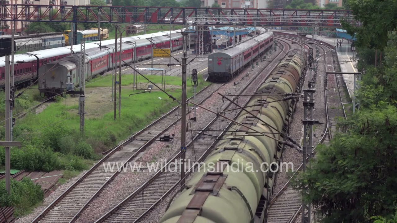Tank wagons crossing railway tracks near Safdarjung train station in New Delhi