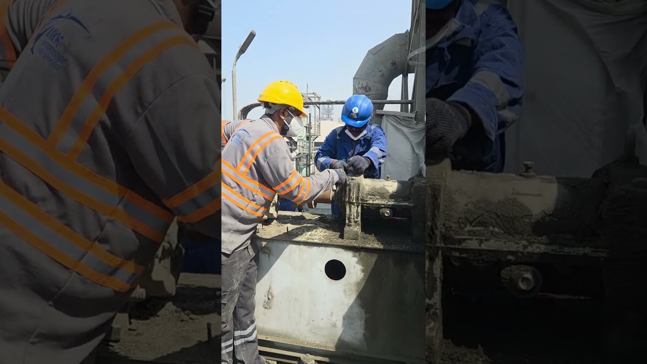 Mobile crane lifting a dust collector motor