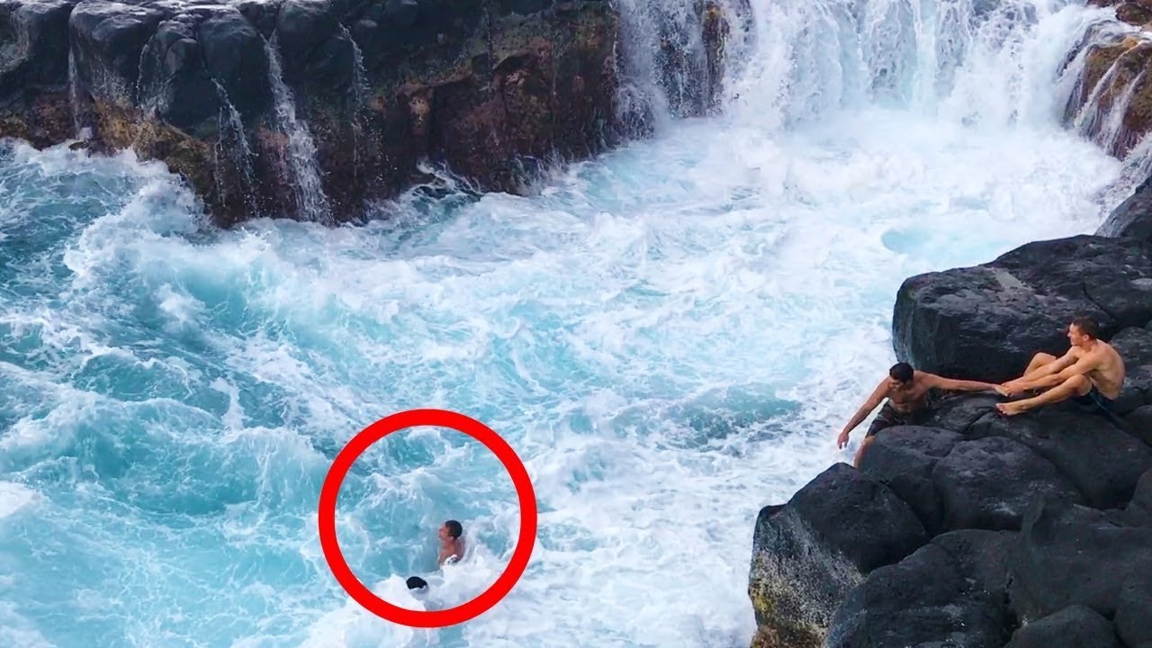 Dangerous! Kid being washed off on the rocks by big wave