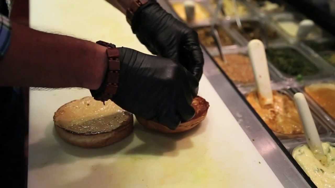 Chef Keith Grober builds a Caca Oaxaca burger at Rodeo Goat
