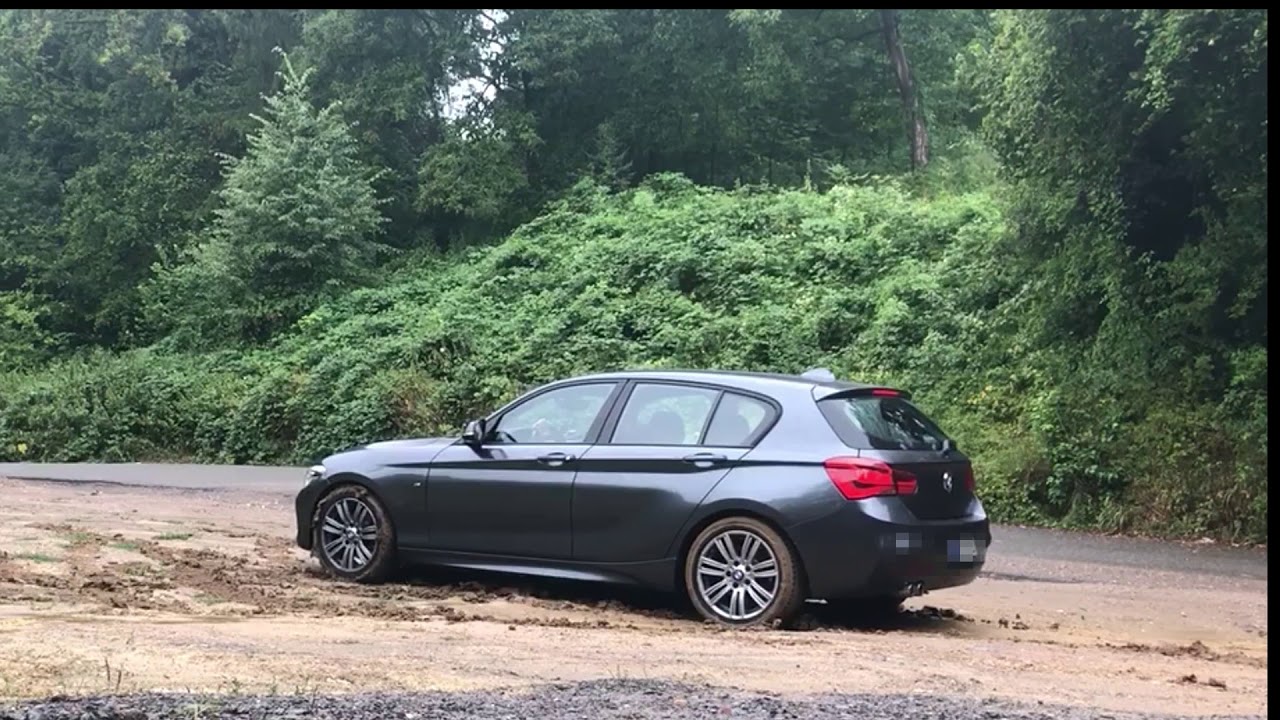 BMW stuck and spinning in the mud
