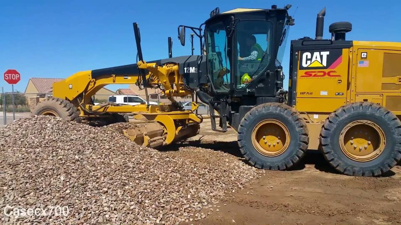 CAT 12M2 Blade Spreading Track-out Rock