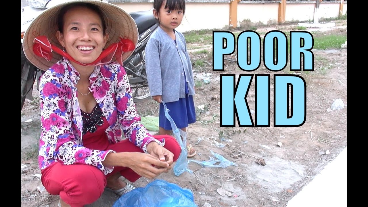 Happy Vietnam kid can't afford toys. Plays with plastic rubbish.