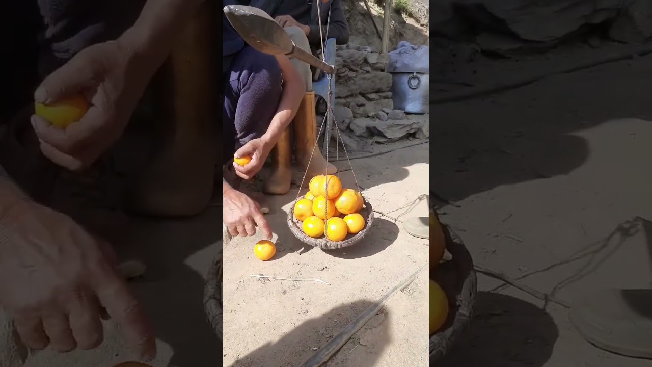Tradition meets utility: Weighing oranges the classic way on a Tulo