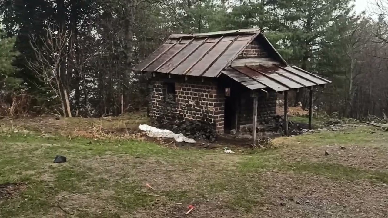 Trekking in rainfall and Snowfall to the ancient buildings in forest
