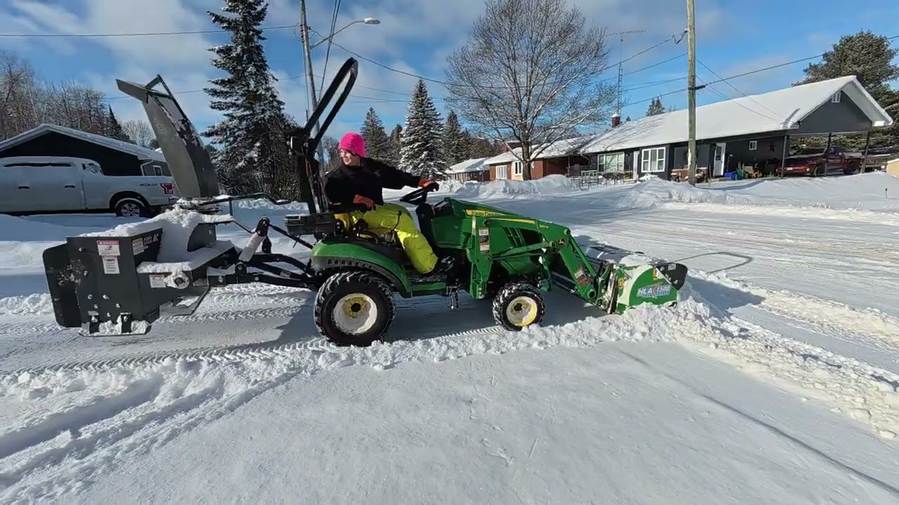 John Deere 1025R pushing snow with HLA 60” pusher