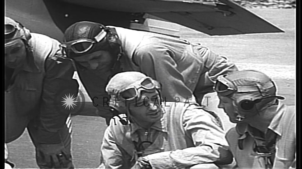 US Navy Fighter pilots of VF-3 sit near an F4F and converse at Kaneohe Bay in Haw...HD Stock Footage
