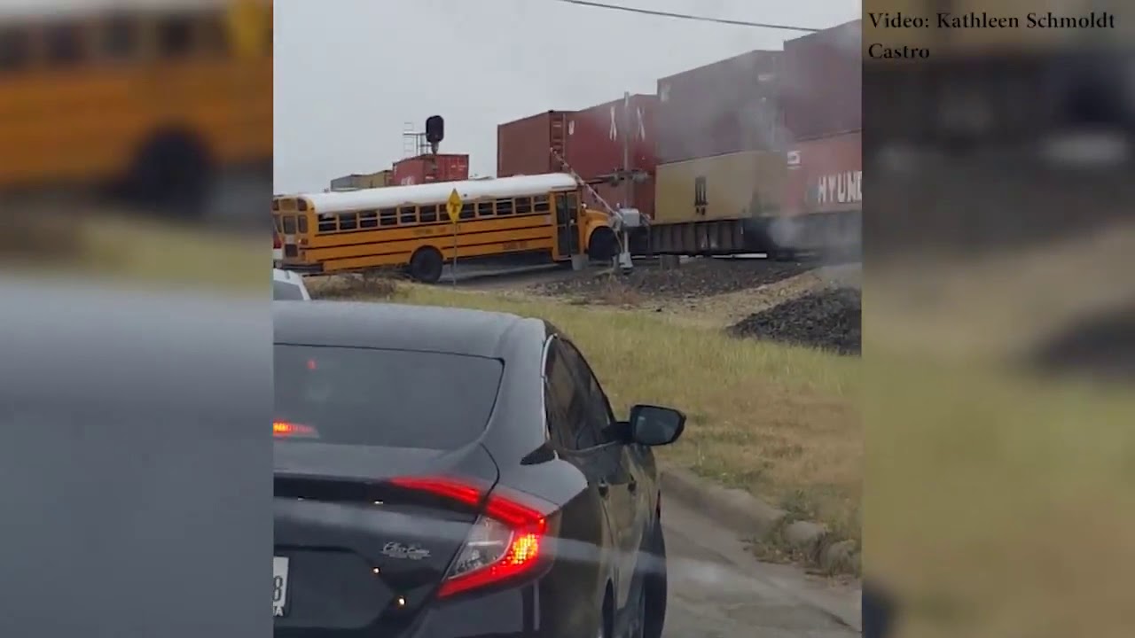VIDEO: School bus tries gets stuck under railroad crossing