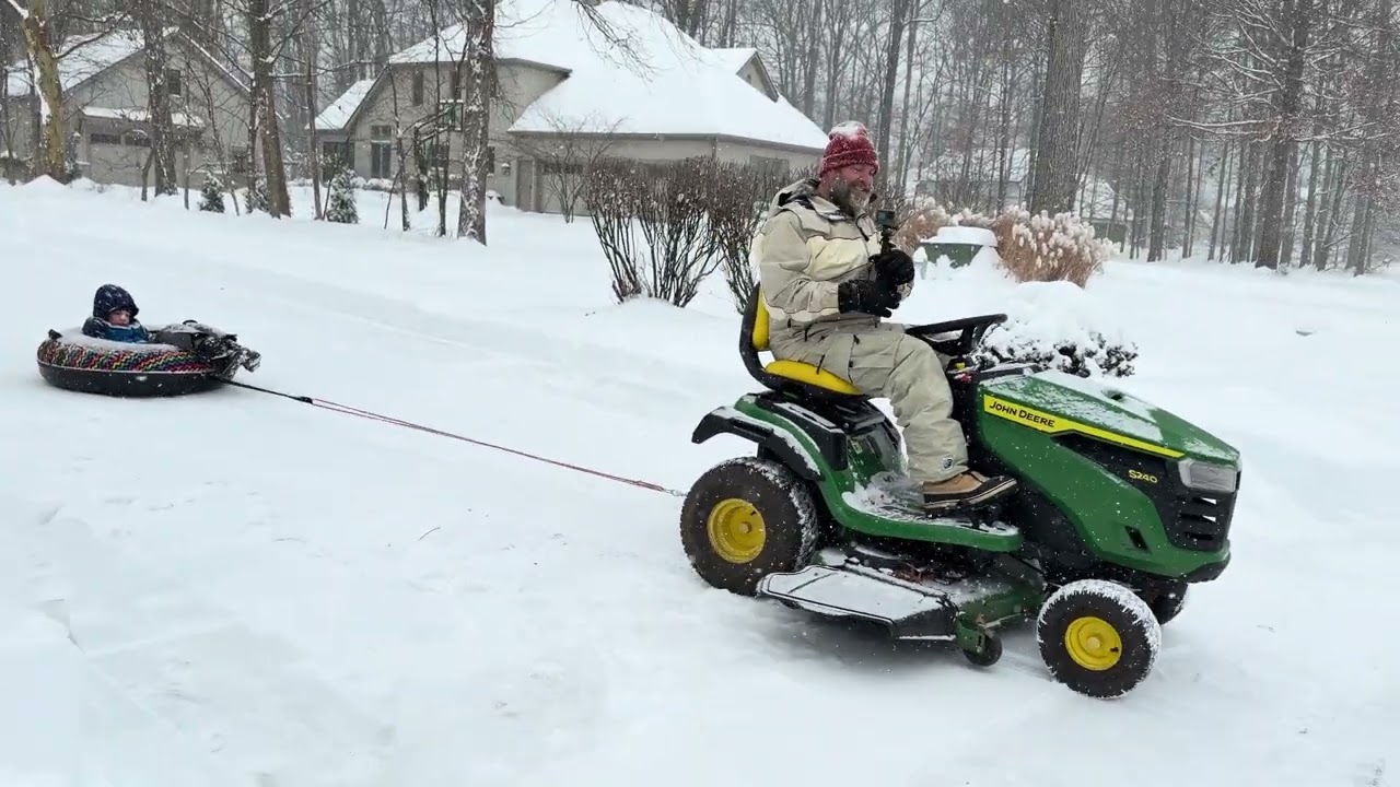 Sledding fun with the lawnmower and snow tube. 