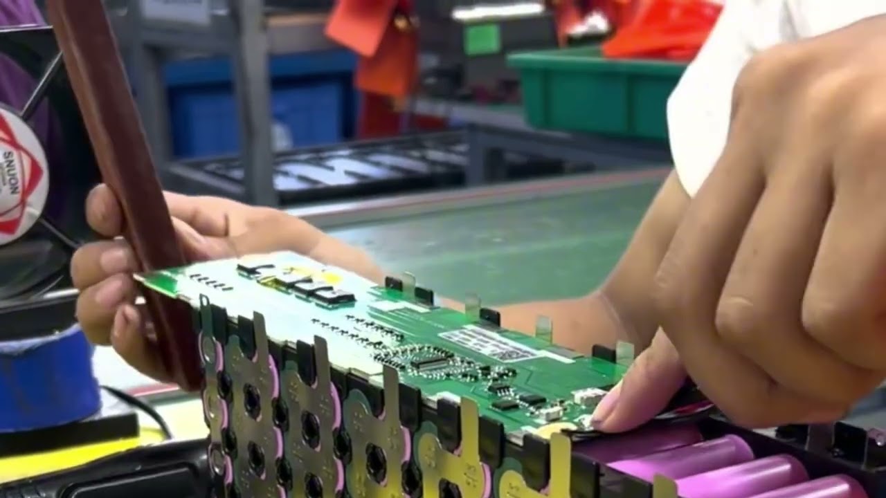 Watch as skilled technician working in perfect harmony to build a high-voltage battery module