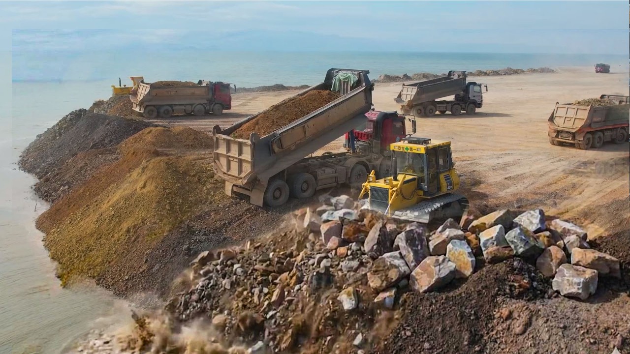 Working SHANTUI dozer Pushing the land away from the sea And Truck Dump 25.5Ton