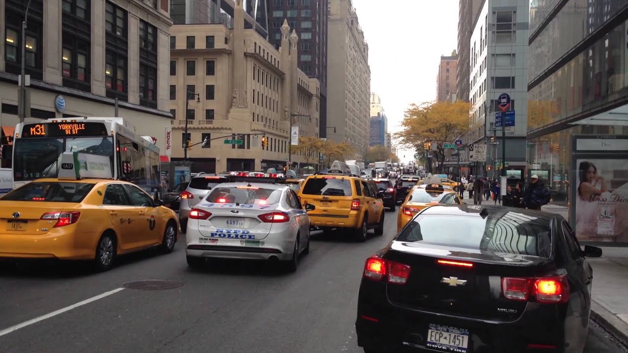 NYPD CRUISER, RESPONDING IN HEAVY TRAFFIC WITH BROKEN RUMBLER SIREN, ON W. 58TH ST. IN MANHATTAN.