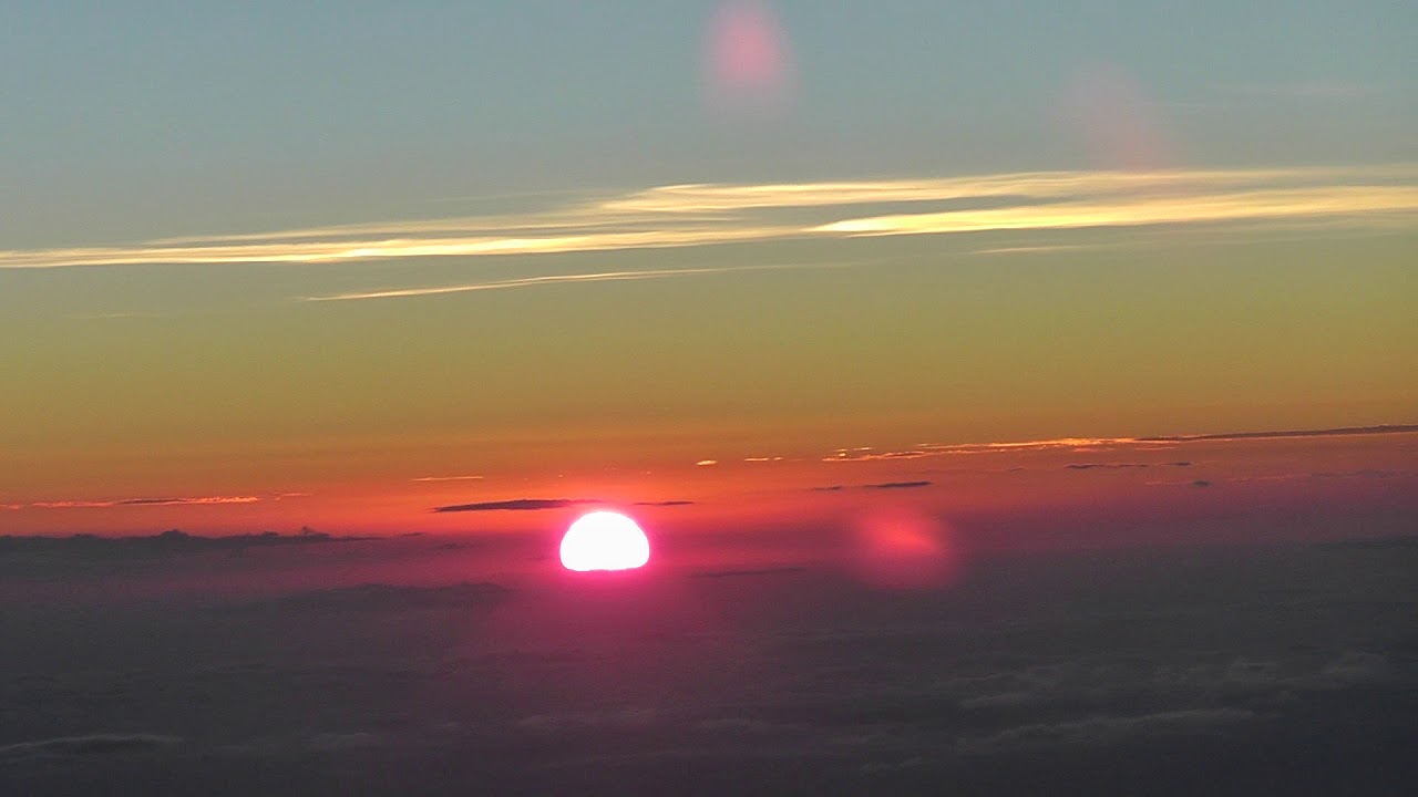 Weird Sunrise Coming Up Under The Clouds