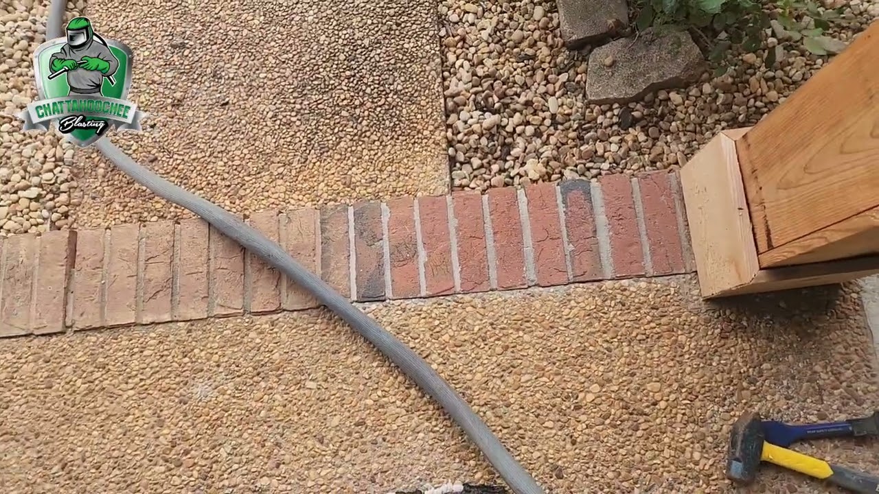 Media blasting mortar from brick and pebble stone.