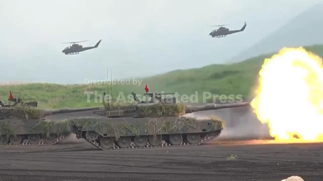 Japan's cabinet approves record defense budget that aims to deter China; AP explains