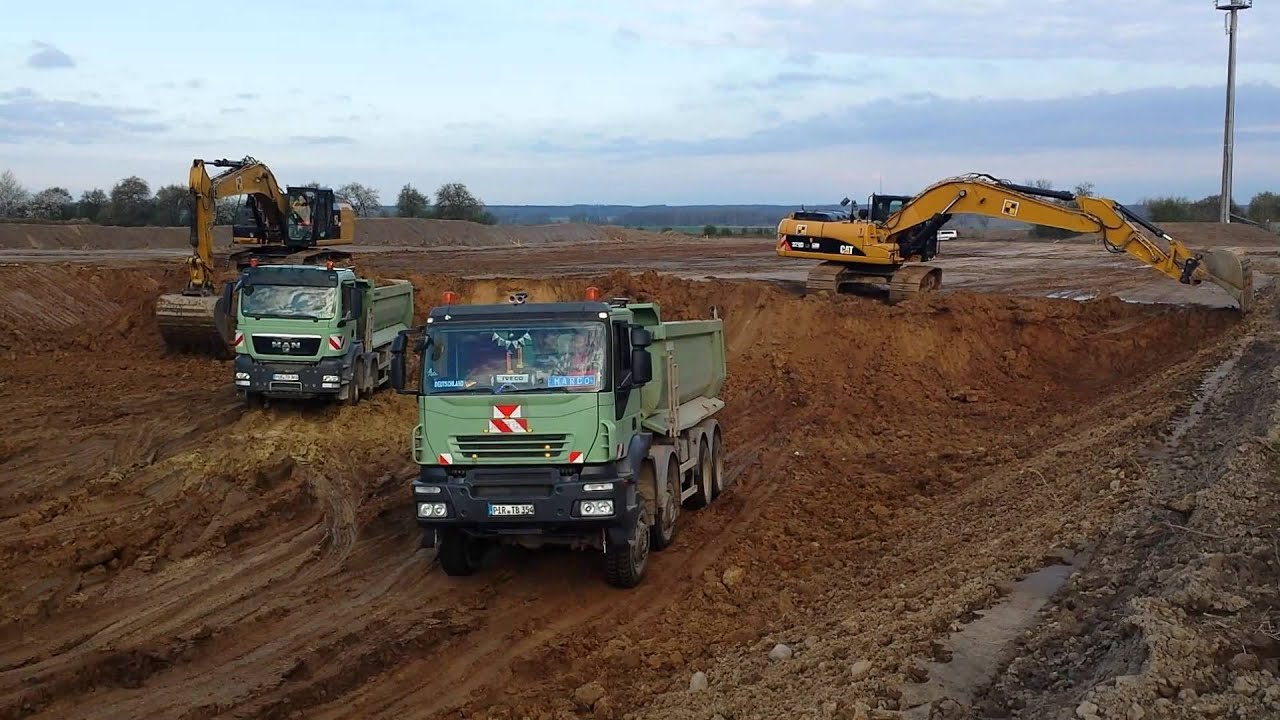 CAT 329D and CAT 329E loading dump trucks