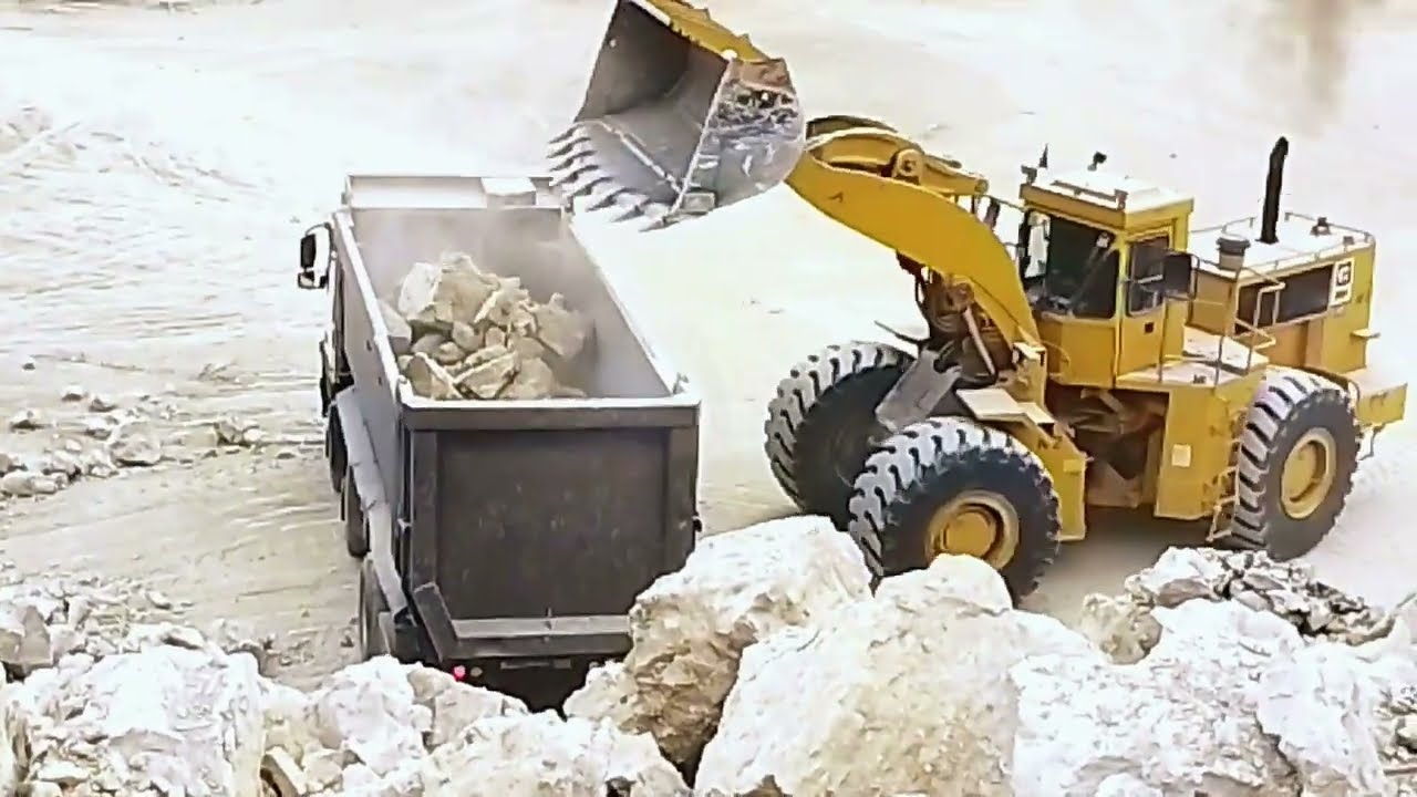 quarry work limestone loading volvo dumper caterpillar loader 980G and 988B