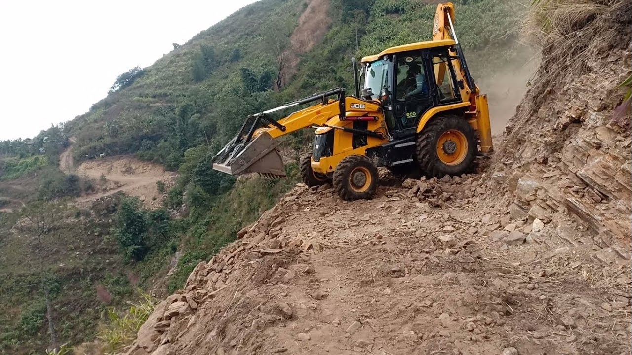JCB Backhoe-Operator Covered With Dust-Makes Remote Hill Track