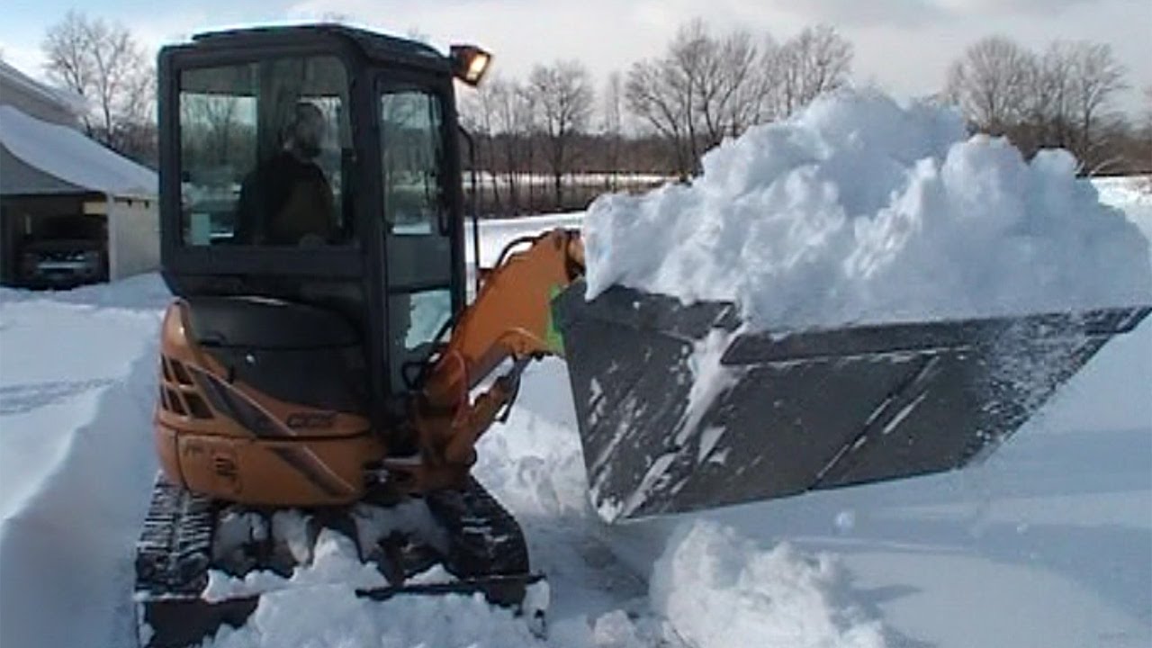 Snow Removal with your Excavator Made Possible with the XBoom Coupler
