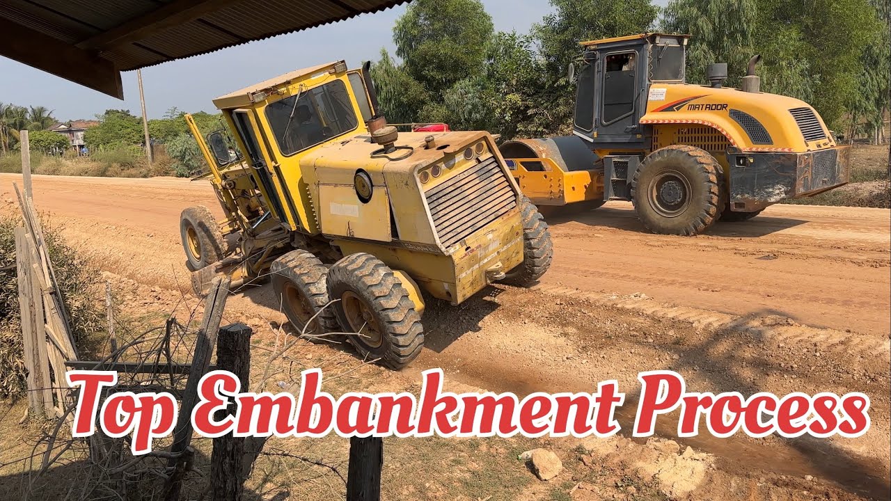 Motor Grader and Heavy Roller Operate Top Layer of Embankment 