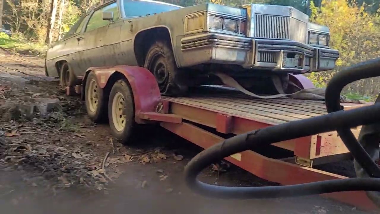 Pulling the Cadillac down the hill out of the woods and loading it on the trailer
