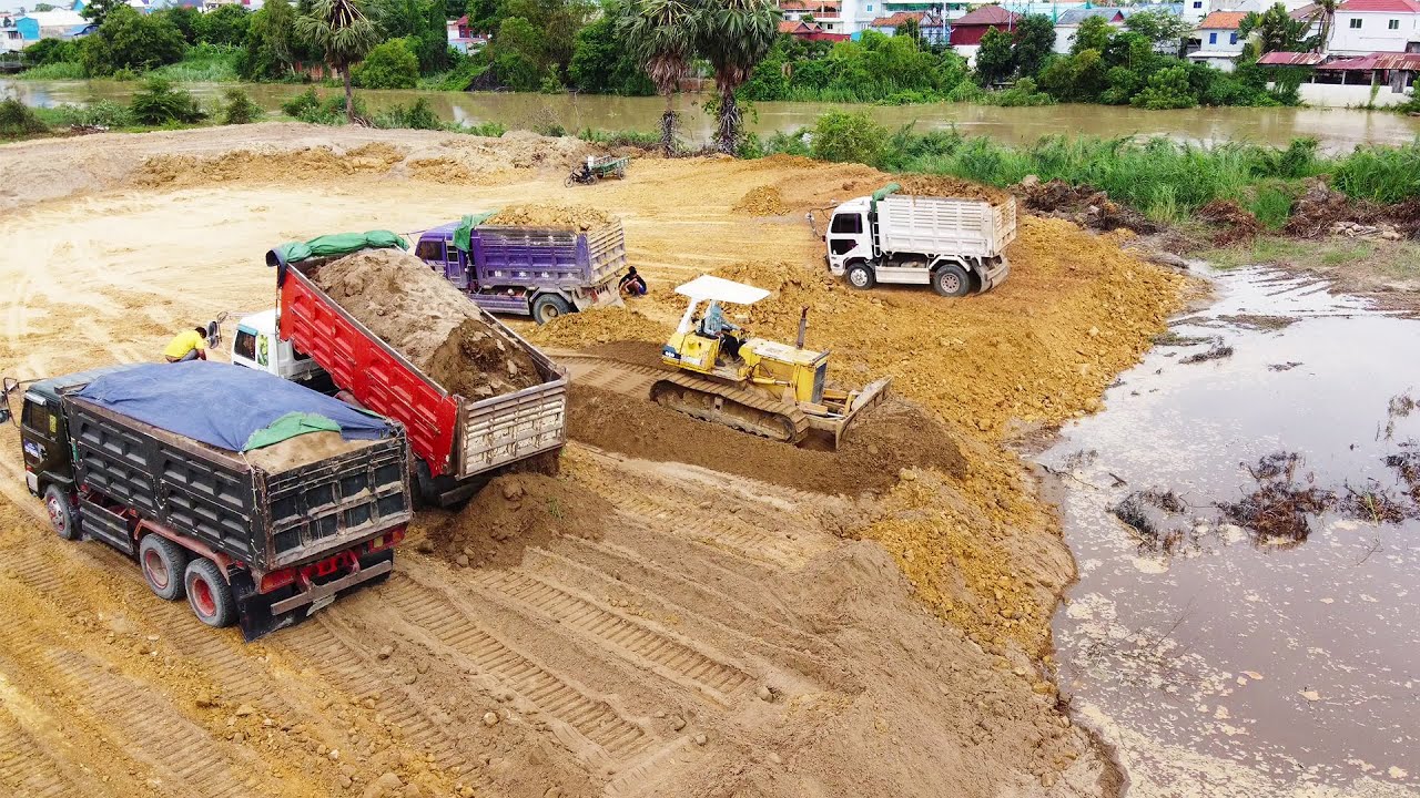 Amazing! Komansu dozer D40P well performing, moving dirt & sand to stop flooding along the river