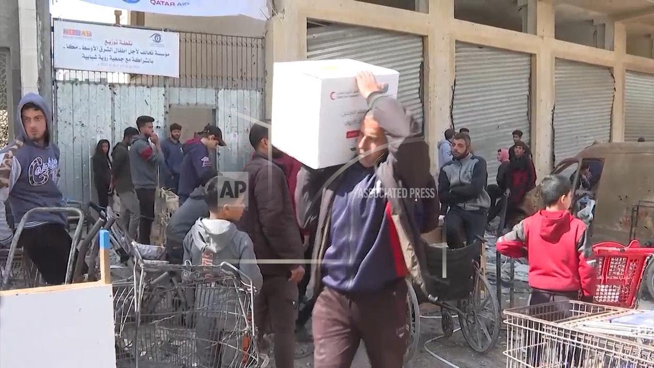 Palestinians line up in Gaza City to receive humanitarian supplies after Israel stops aid trucks