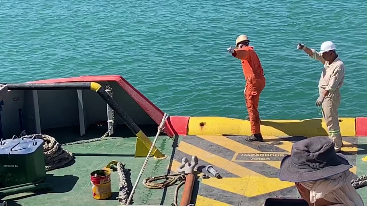 How the tug connecting her tow line to the barge....