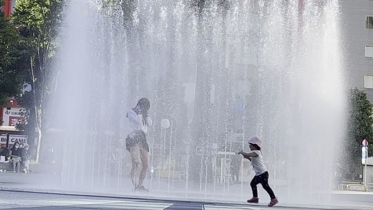 地面から噴き上げる水がスカートを翻す