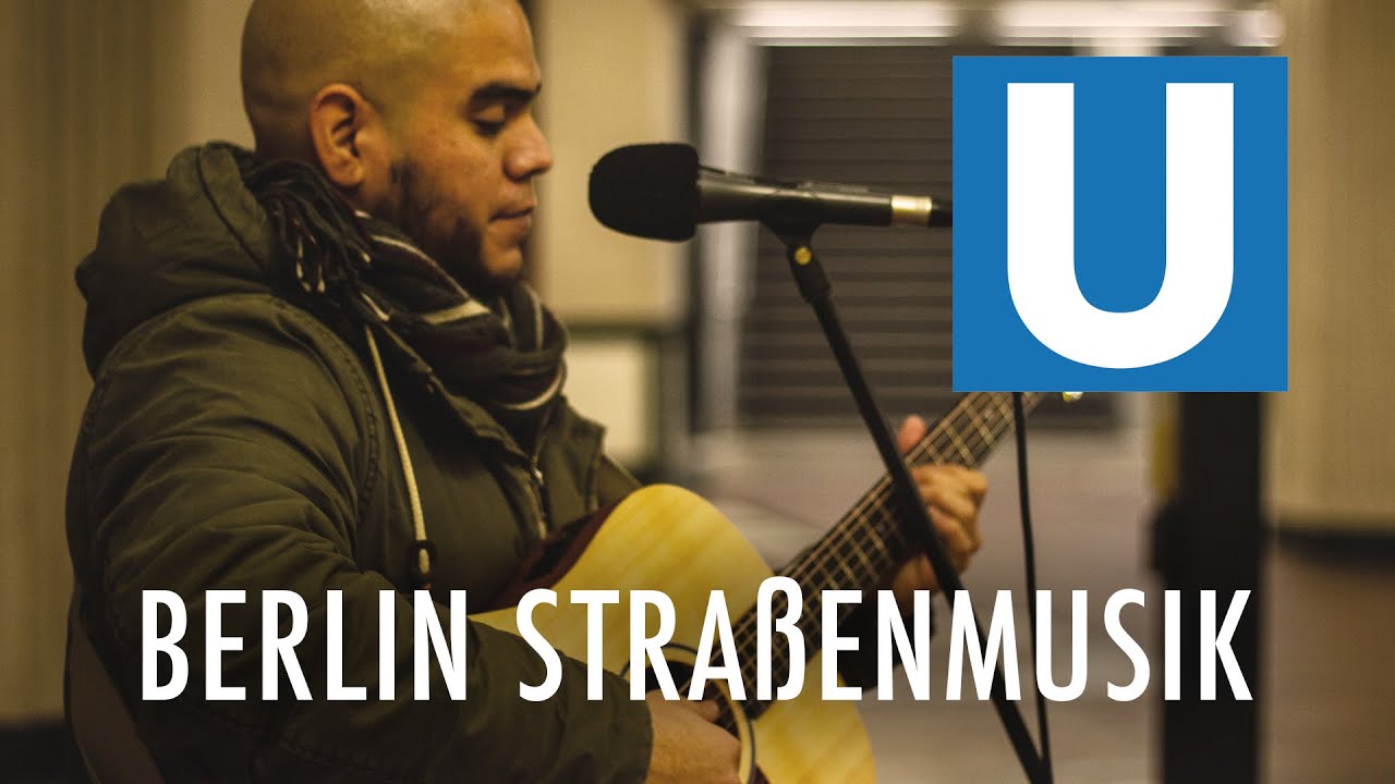 Stra&szlig;enmusiker Playing Guitar at the U-Bahn in Berlin