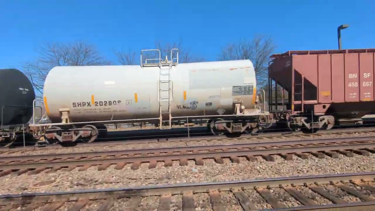 (Uncommon) Two H2 BNSF locomotives lead a westbound manifest past the station on the BNSF racetrack 