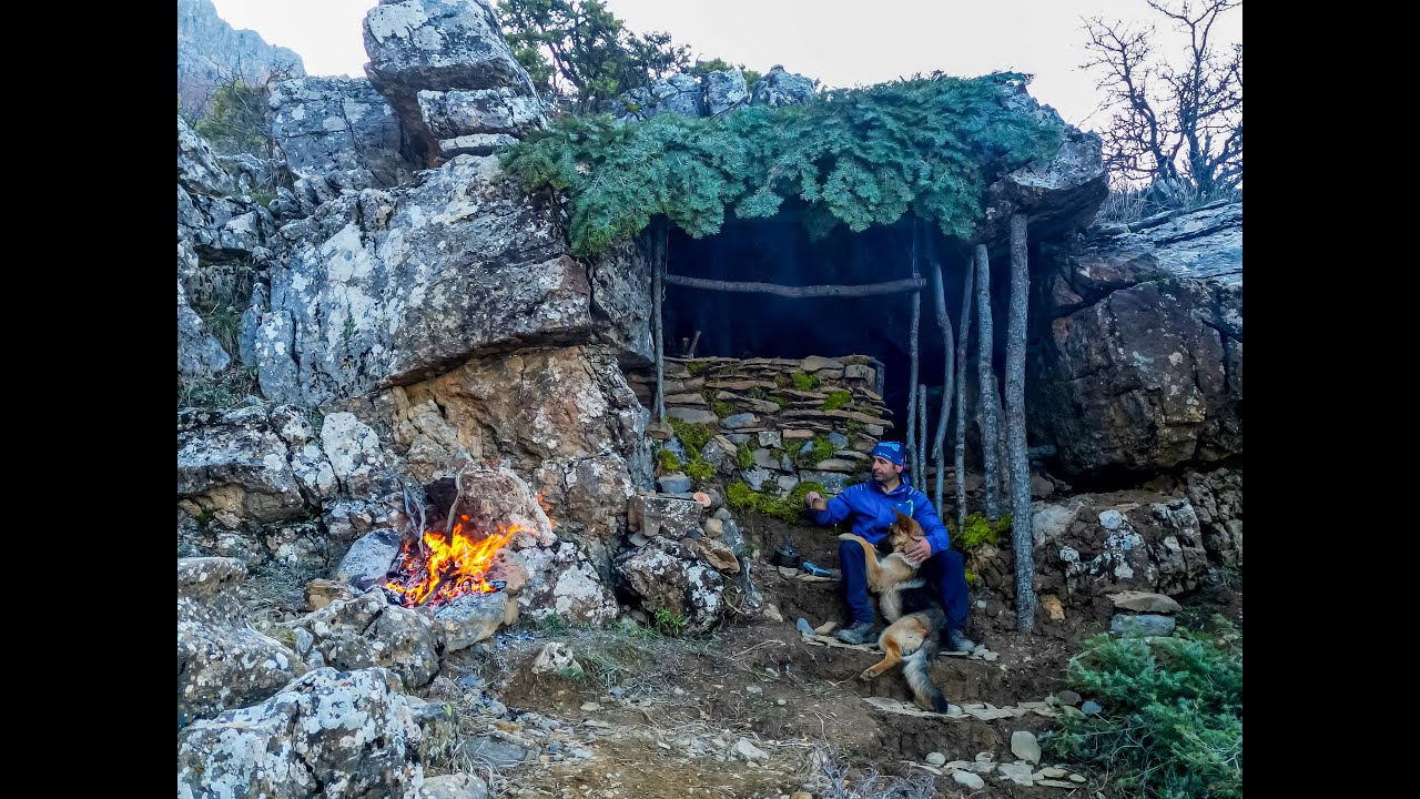 Shelter inside the rock, warm concept, having a good time in the mountains with my energizing dog