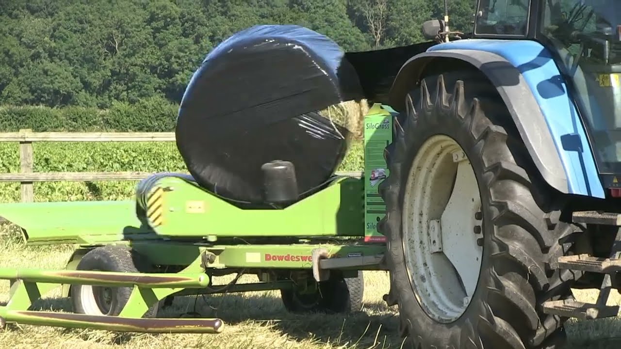 NEW HOLLAND TS115 AND DOWDESWELL BALE WRAPPER