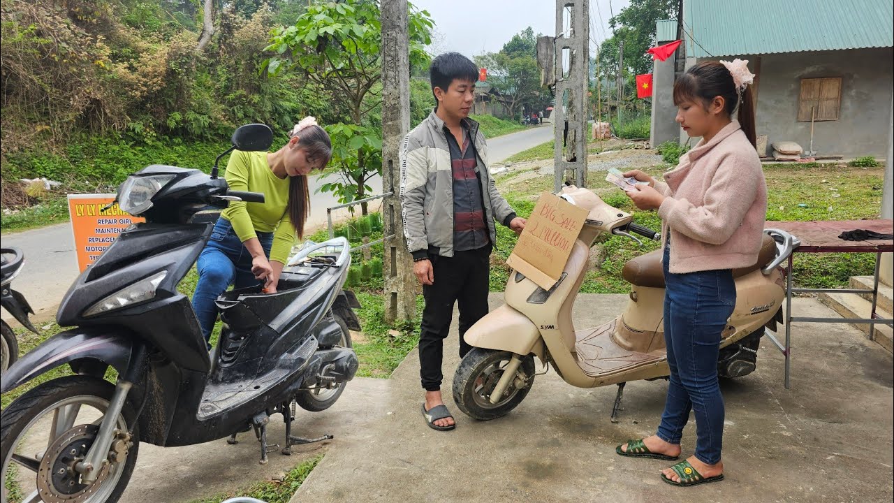 The girl's motorcycle repair shop was fixing a scooter for a potential customer.