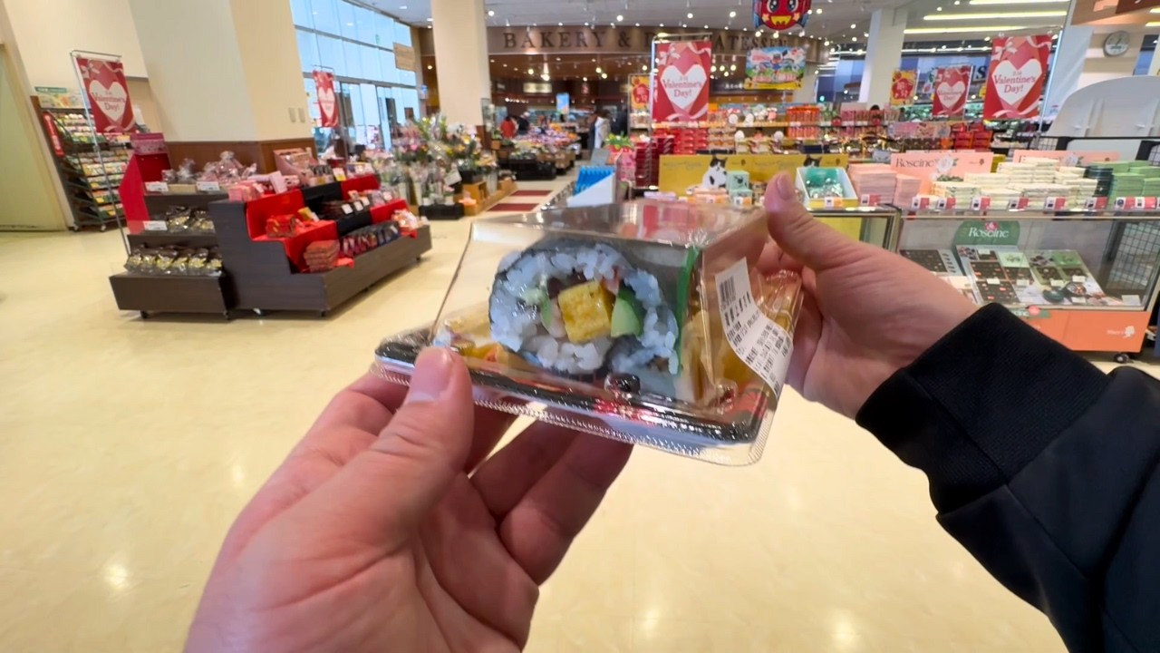 A Japanese salarymen eating Ehomaki rolls on Setsubun