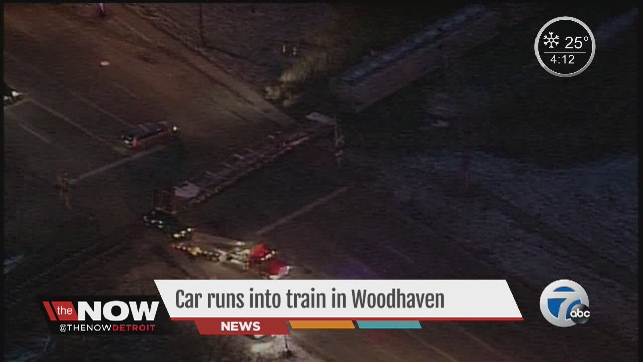 Car runs into train in Woodhaven