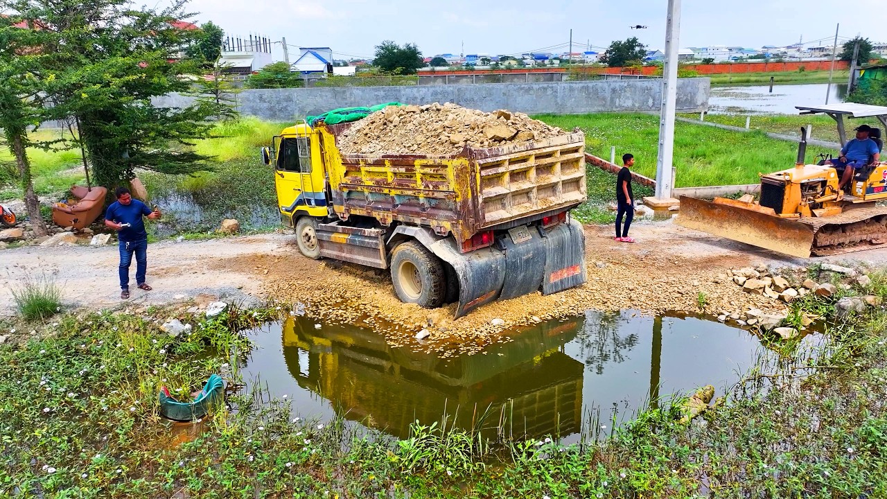 incredible landfill build house project , truck 5Ton transport soil , bulldozer push soil to water