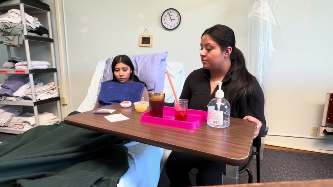 CNA assisting a dependent client with a meal 