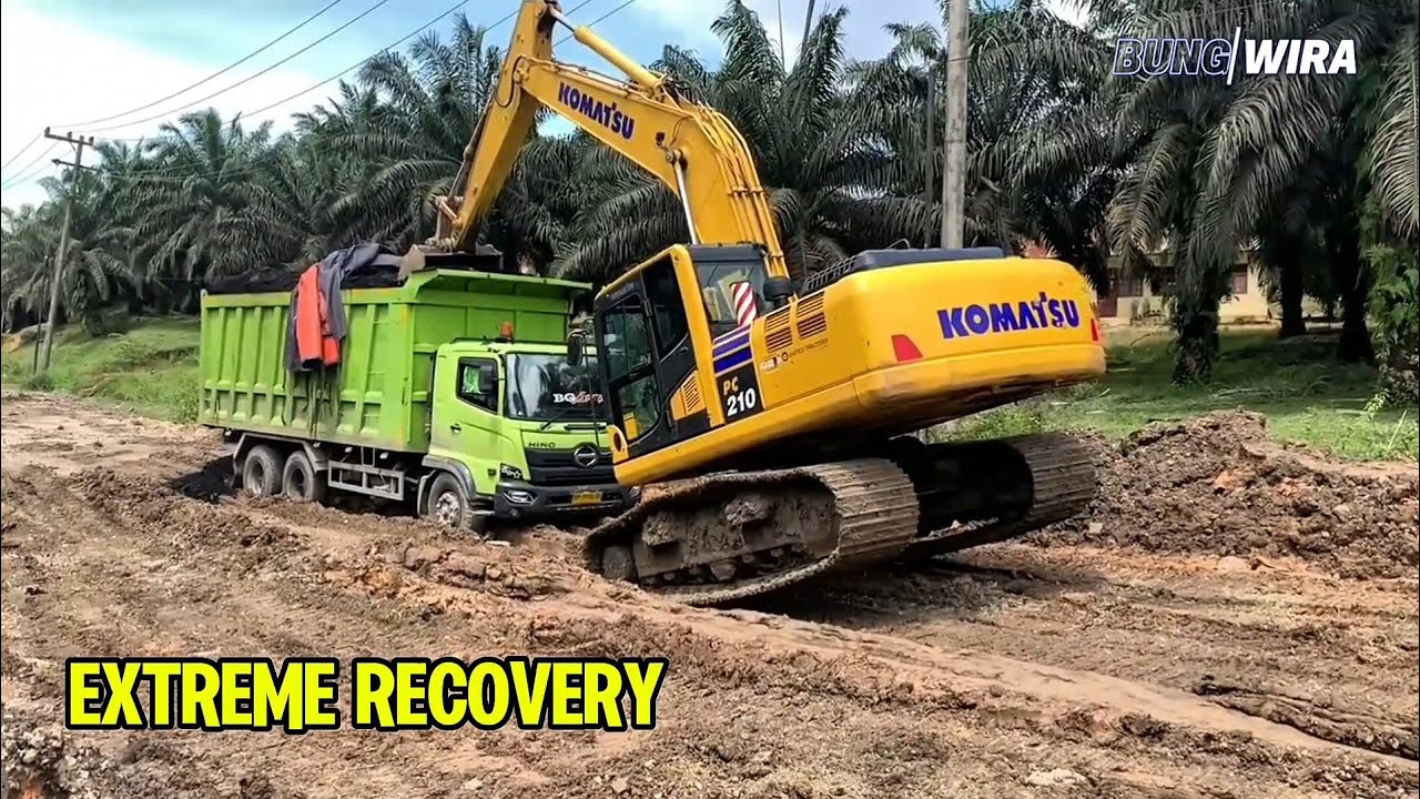 Heavy Excavator Rescues Dump Truck Stuck in Deep Mud
