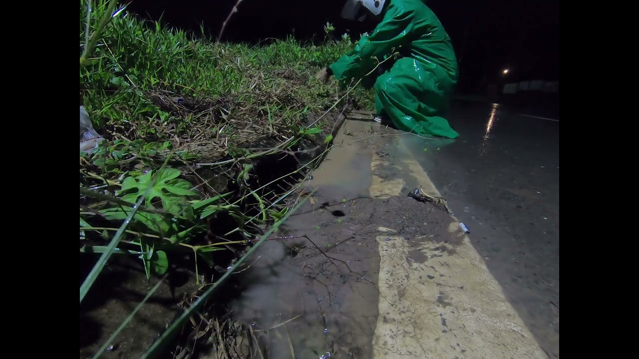 unclogging culvert remove grass clogging culvert/ at night