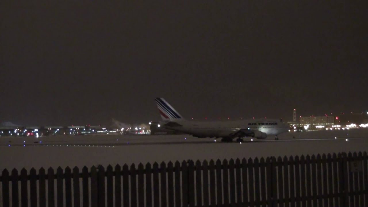 JUMBO JET BLASTS SNOW ON A WINTER STORMY NIGHT TAKEOFF