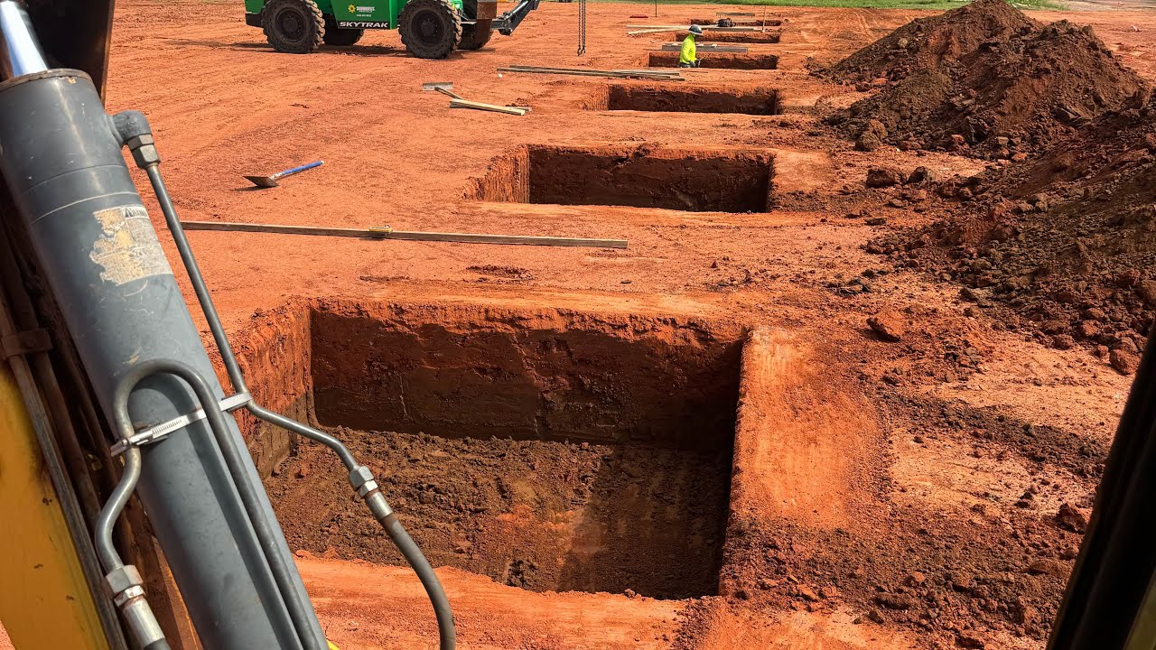 Learn how to dig spot footings. #backhoebasics