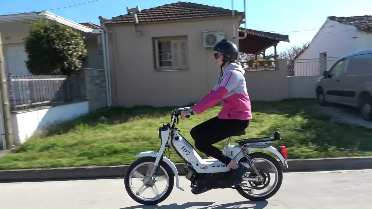Girl riding Peugeot Vogue moped
