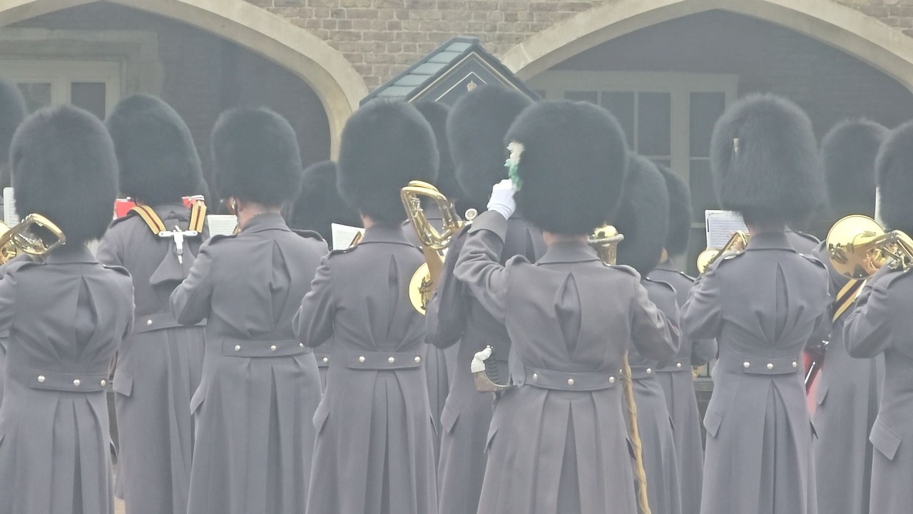Caring Moment Drum Major Adjusts Guards Ear Piece