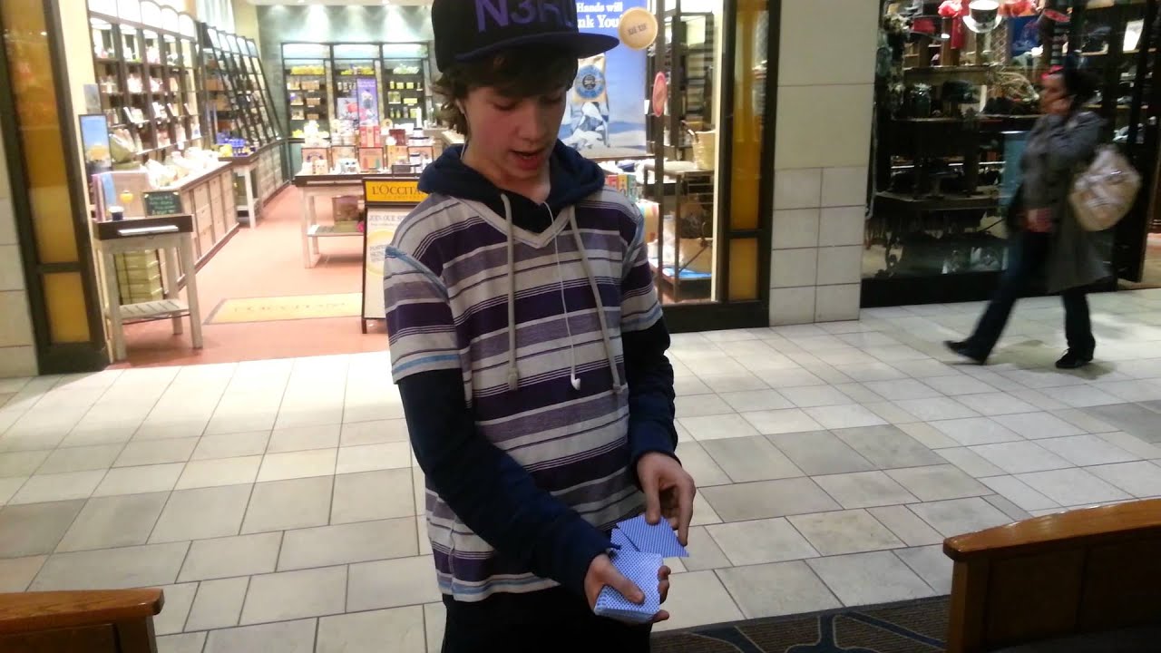 Some kid doing crazy card tricks at the mall