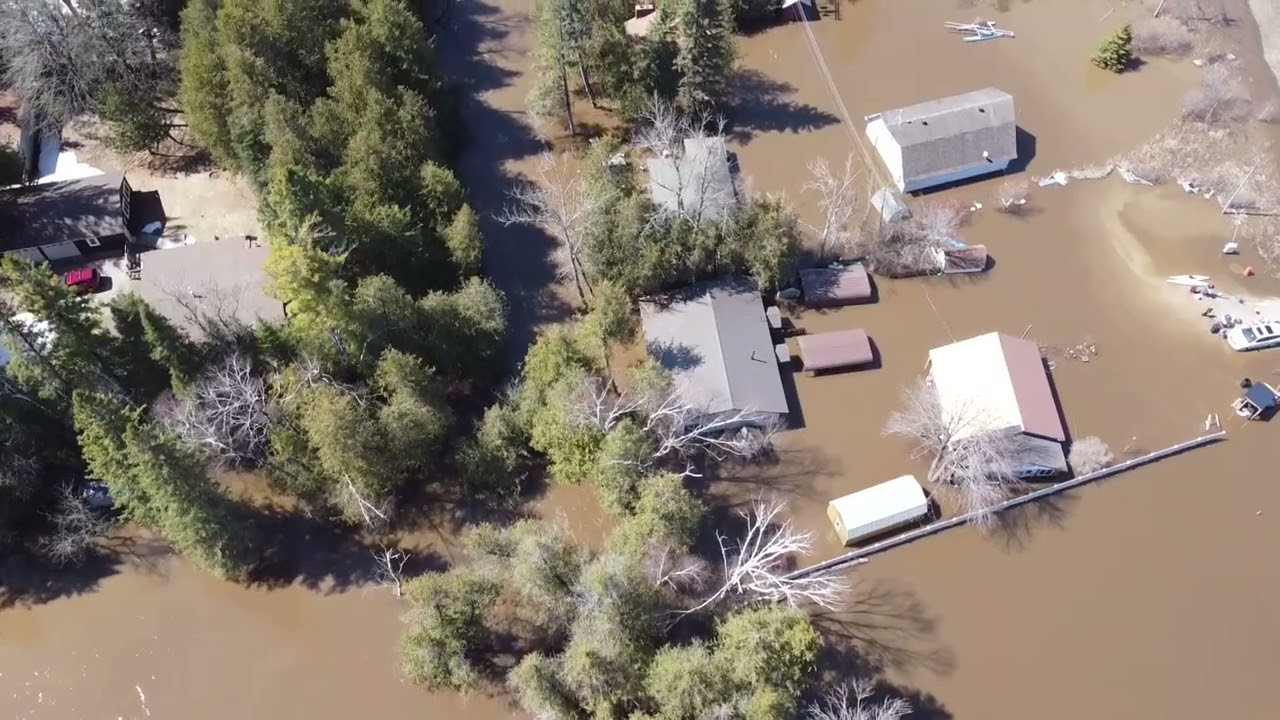 Aerial footage shows houses flooded by the Sturgeon River