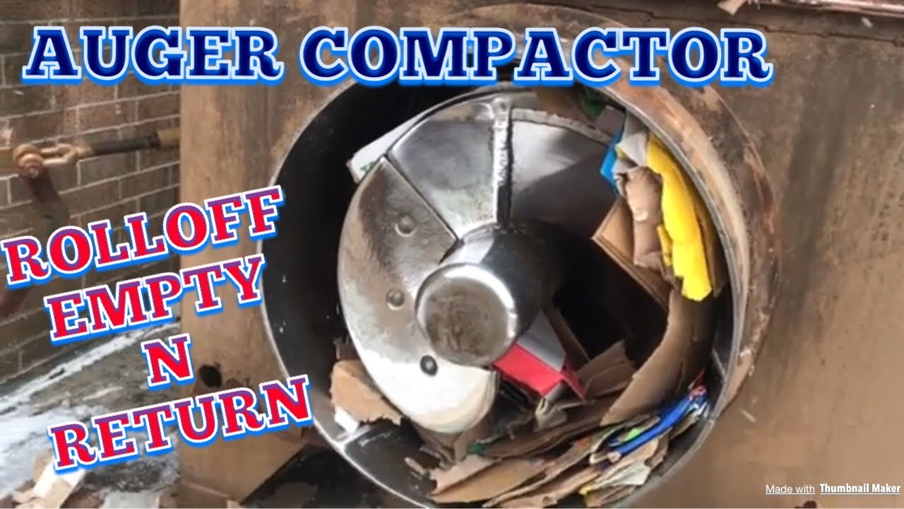 Garbage truck dumps an auger compactor with cardboard