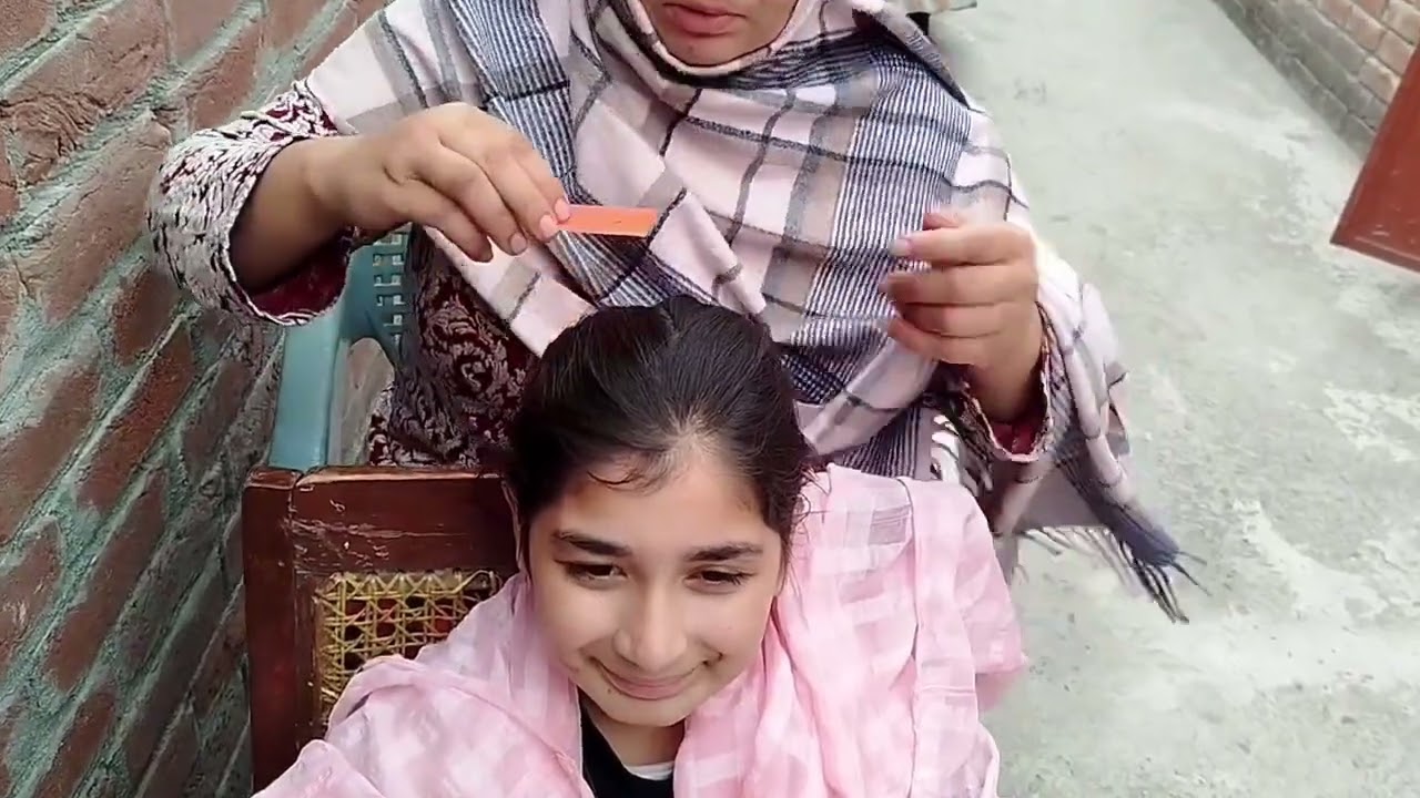 Maryam,s hair checking of her mother.